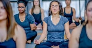 women dealing with anxiety in a yoga class