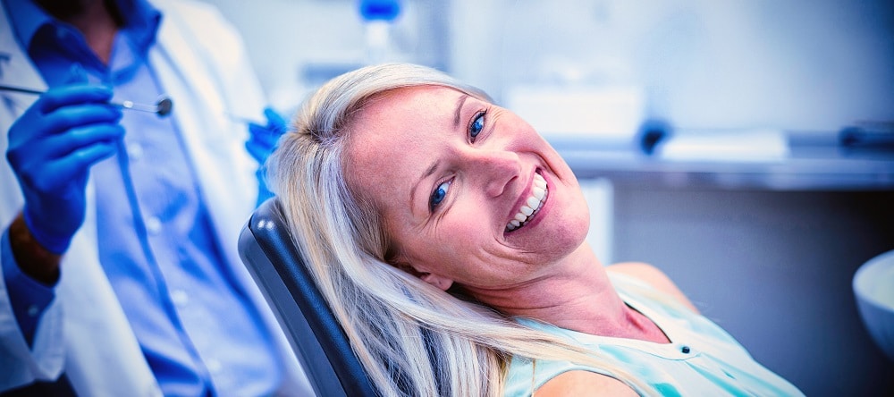 Portrait,Of,Female,Patient,Smiling,In,Dental,Clinic
