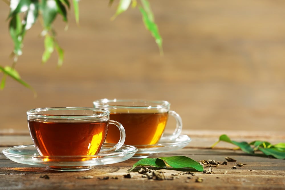 Cups,Of,Green,Tea,On,Table,On,Wooden,Background