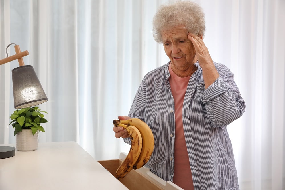 Senior,Woman,Finding,Bananas,In,Chest,Of,Drawers,At,Home.