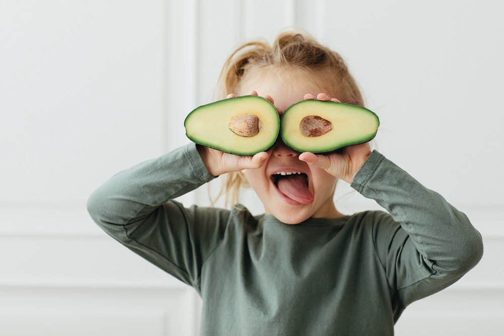 Green,Nature,Colores.,Excited,Child,Girl,Covering,Eyes,Avocado,Halves